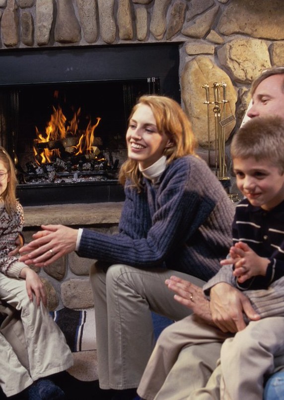 Family relaxing by a clean, safe fireplace